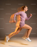 Athletic woman sprinting in motion blurred studio shot