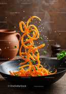 Fresh carrot noodles and peas tossed in hot wok
