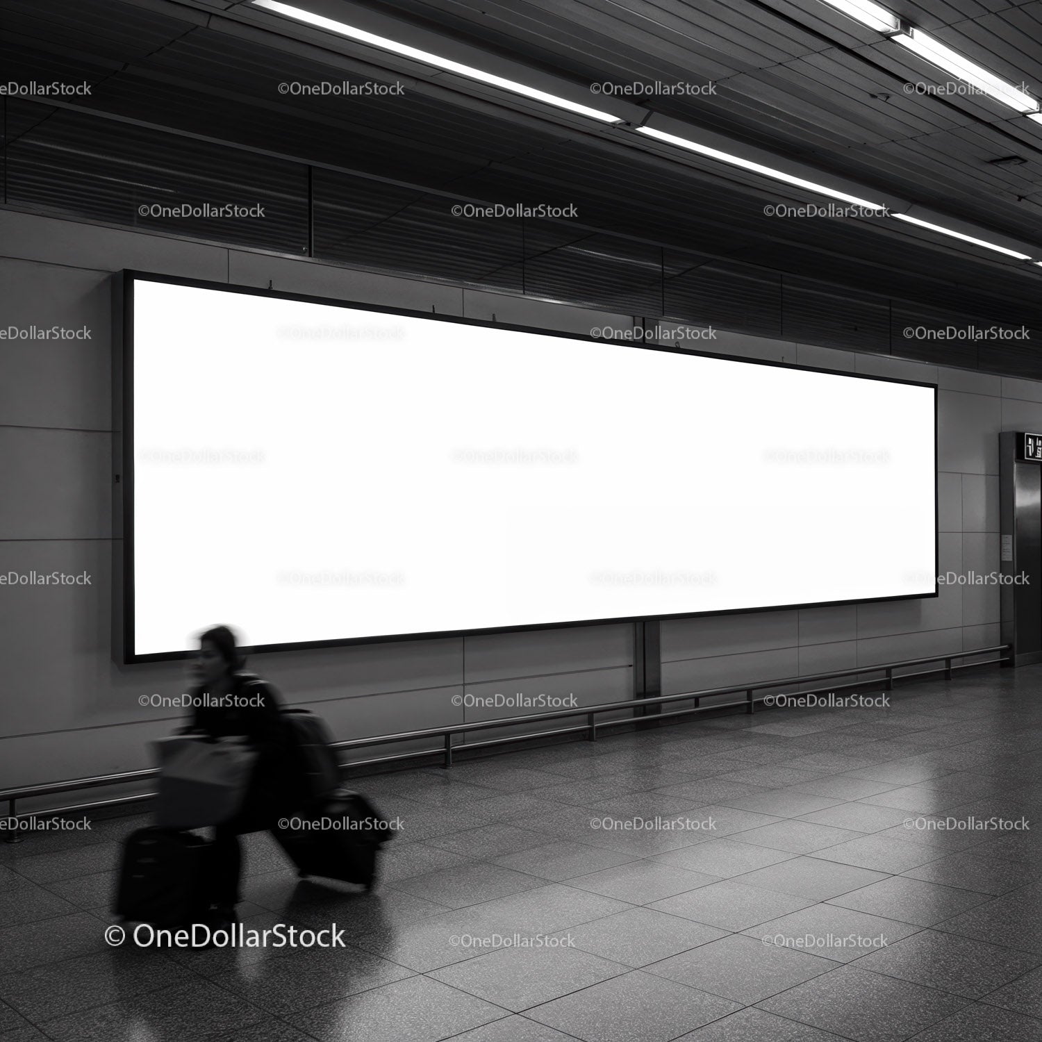 Traveler walking past large blank billboard in subway station