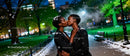 Couple Sharing a Tender Kiss on Snowy Evening Walk