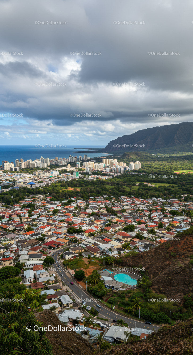 Panoramic View of Coastal City with Mountains and Ocean in Background