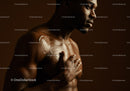 African Man with Moisturizing Body Lotion in Elegant Studio Portrait