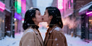 Couple sharing a tender kiss in snowy urban evening