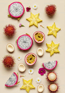 Assorted tropical fruits and delicate flowers on beige