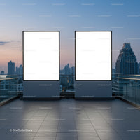Two blank billboards on rooftop with city skyline