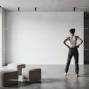 Woman contemplating blank wall in modern minimalist room