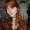 Vibrant Red-Haired Woman with Blue Eyes in Stylish Indoor Portrait