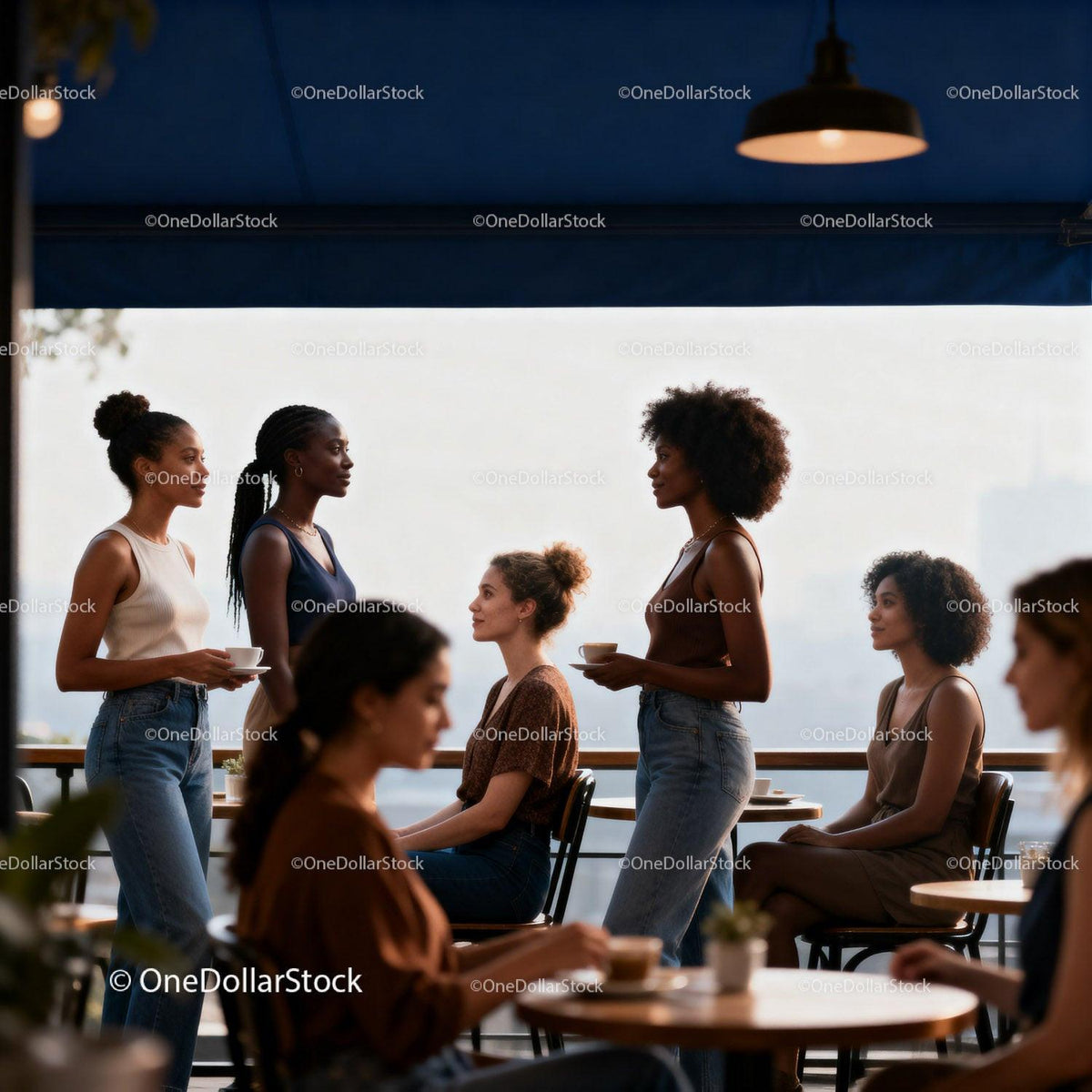 Stylish women enjoying coffee and conversation outdoors