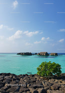 Overwater Bungalows and Turquoise Ocean Under Clear Blue Sky