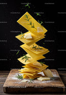 Floating lasagna sheets with cheese and fresh herbs