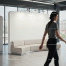Modern curved beige sofa in bright office lobby
