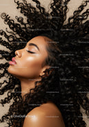 Close-up of woman with natural curly hair and glowing skin