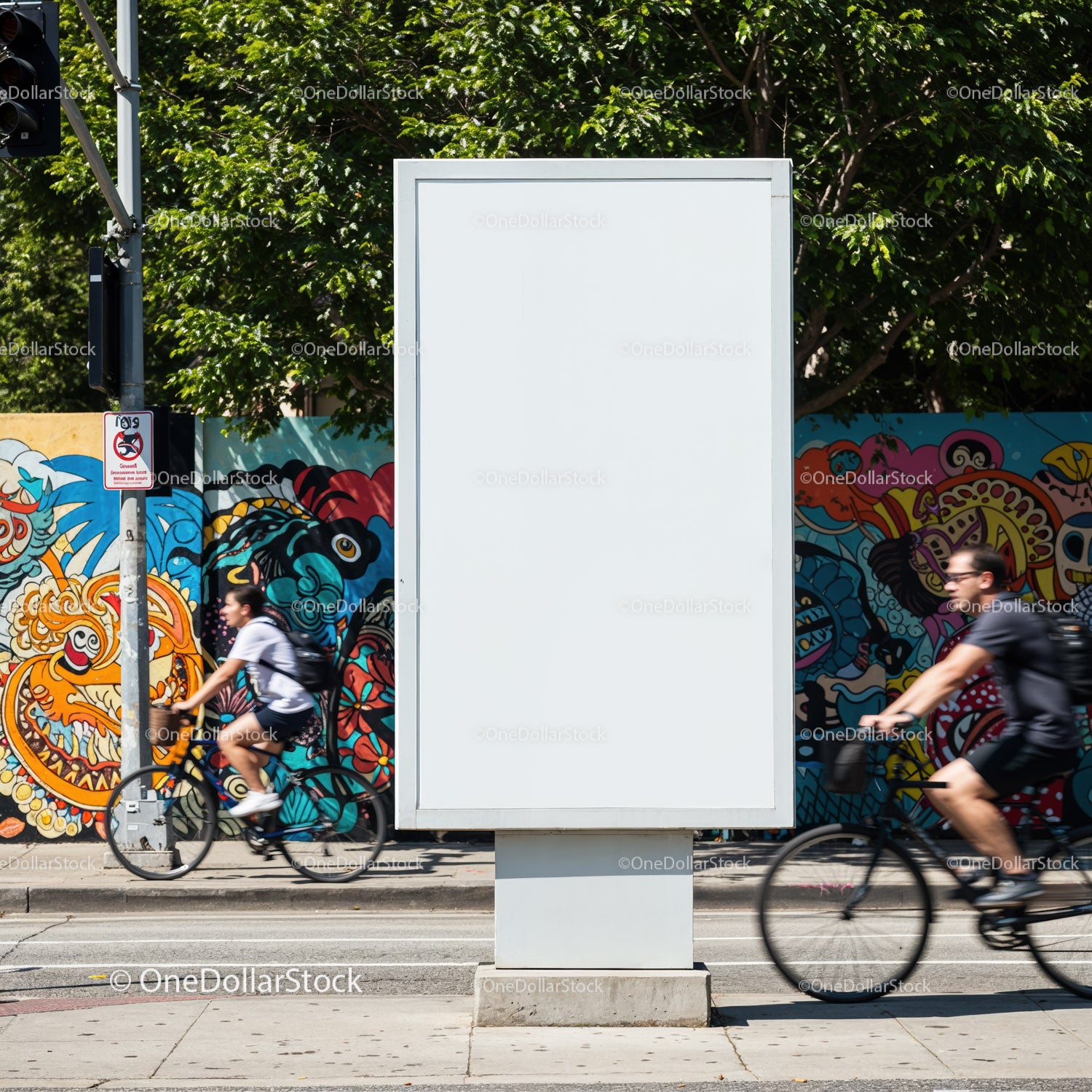 Empty urban billboard with cyclists passing vibrant mural