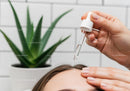 Serum Application During Facial Skincare Treatment with Aloe Vera Plant