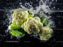 Fresh Cauliflower and Leafy Greens Splashing Water