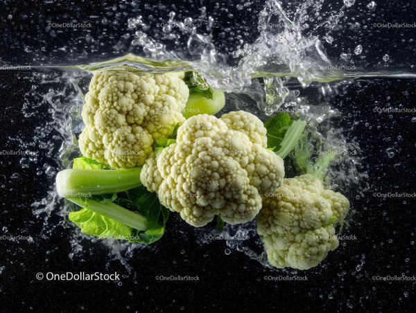 Fresh Cauliflower and Leafy Greens Splashing Water