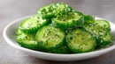 Fresh Sliced Cucumbers in White Bowl on Wooden Surface
