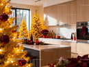 Modern kitchen decorated with festive golden Christmas trees
