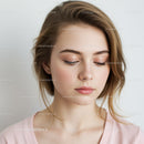 Young Woman with Flawless Skin and Soft Expression in Beauty Portrait