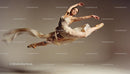 Graceful ballet dancer performing an elegant leap