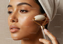 Asian Woman Receiving Facial Massage with Jade Roller for Skin Rejuvenation