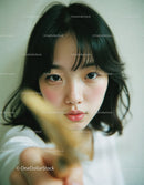 Young Woman Touching Camera Lens with Blue Eyes and Black Hair
