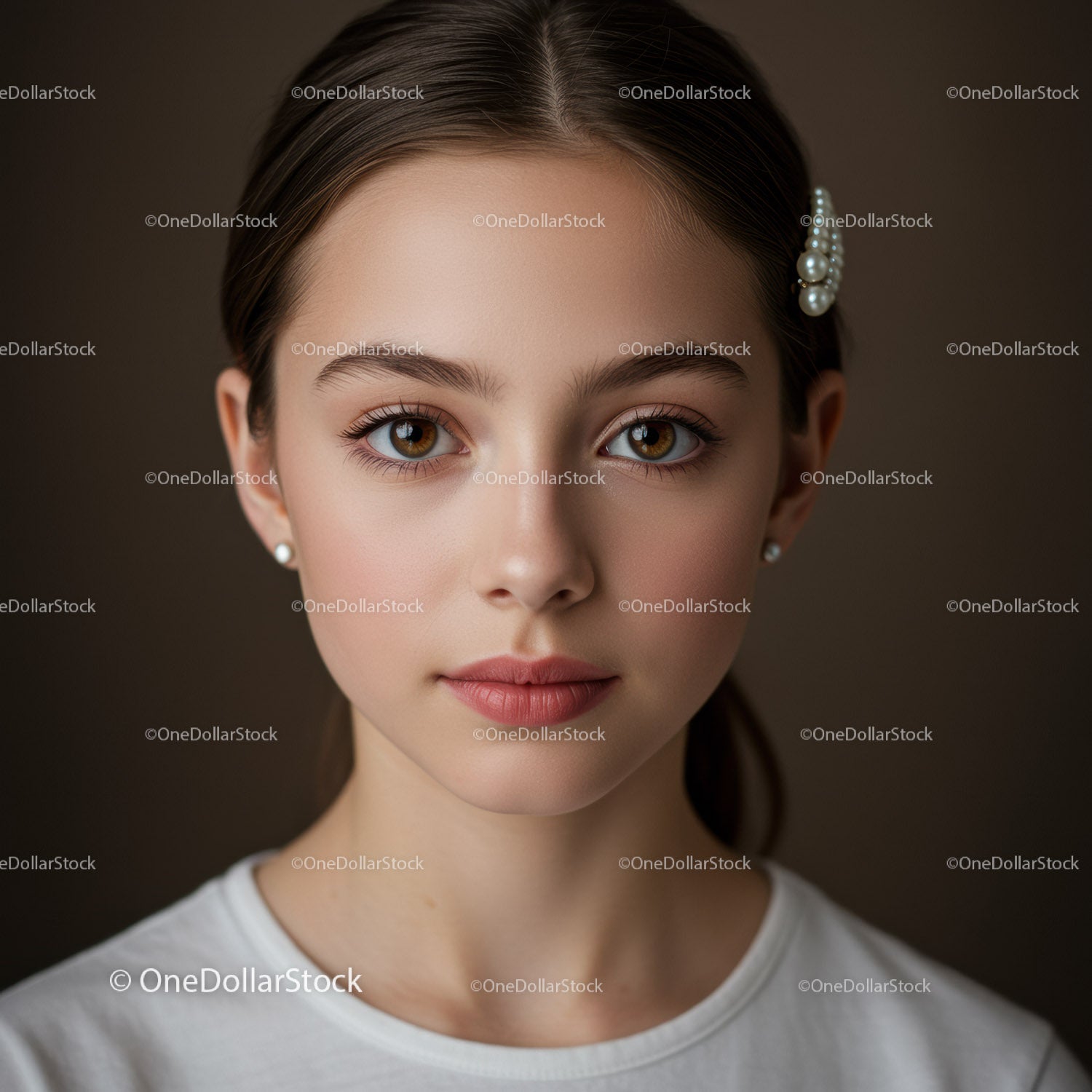 Elegant Young Woman with Brown Eyes and Pearls in Studio Portrait