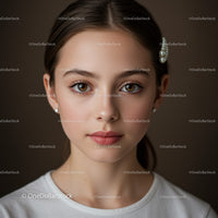 Elegant Young Woman with Brown Eyes and Pearls in Studio Portrait