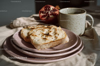 Fresh Herb Sliced Bread with Pomegranate and Tea on Rustic Table