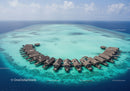 Overwater Bungalows in Turquoise Lagoon on Tropical Island