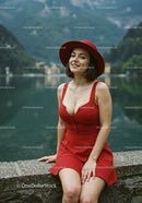 Elegant Woman in Red Dress and Hat Enjoying Scenic Lake View