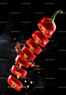 Fresh Red Chili Pepper Slices with Splash on Black