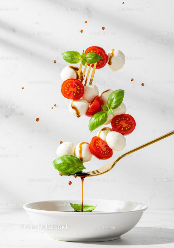 Caprese salad ingredients flying over white plate