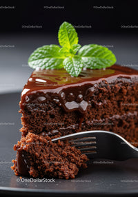 Close up of moist chocolate cake slice with fresh mint