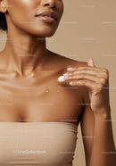 Close-Up of Woman Applying Moisturizer to Glowing Skin