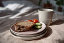 Fresh Whole Grain Bread with Cucumber and Cherry Tomatoes in Cozy Breakfast Setting