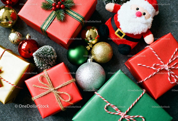 Christmas gifts and festive decorations on dark surface