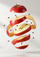 Floating sliced red apple with peeling and seeds