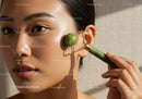 Young Woman Using Jade Roller for Face Skincare Facial Massage
