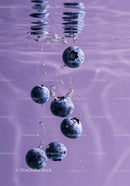 Fresh blueberries submerged in clear water with bubbles