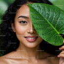 Young Woman with Green Tropical Leaf in Close-Up Portrait