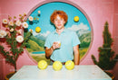 Young Man with Tennis Balls and Coffee in Artistic Colorful Room