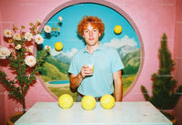Young Man with Tennis Balls and Coffee in Artistic Colorful Room