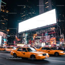 Yellow taxis speeding through busy city intersection at night
