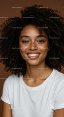 Portrait of a Smiling Young Woman with Curly Hair in Studio