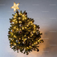 Decorated Christmas tree with glowing star topper