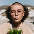 Fashionable Woman with Green Juice in Outdoor Sunny Setting