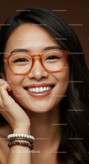 Smiling young woman with stylish orange glasses and bracelets