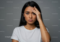 Stressed Woman Holding Her Forehead Expressing Anxiety and Frustration