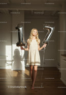 Young woman celebrating seventeenth birthday indoors